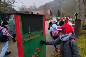 a person touching a green board with red blocks on it