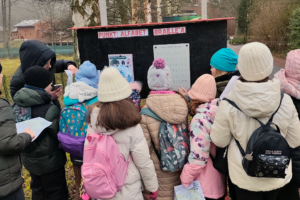 a group of people standing in front of a sign